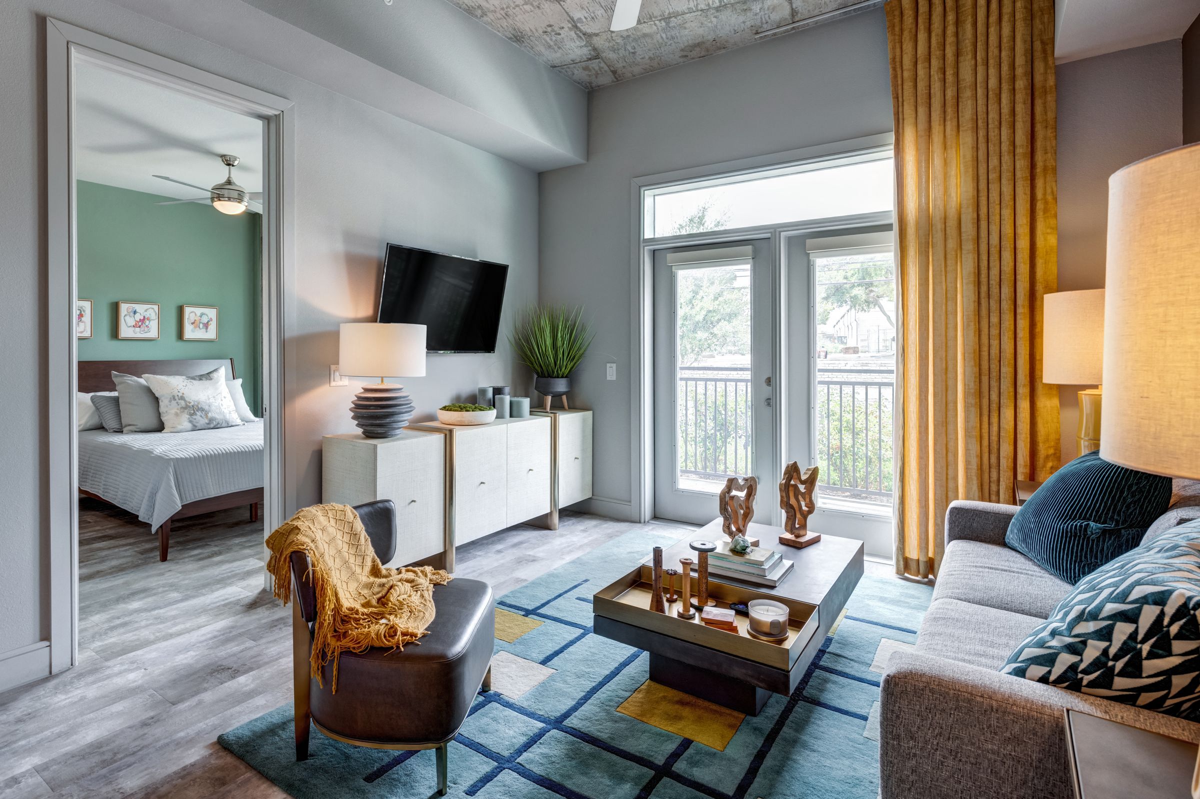 a living room with a couch and a table   and a bed